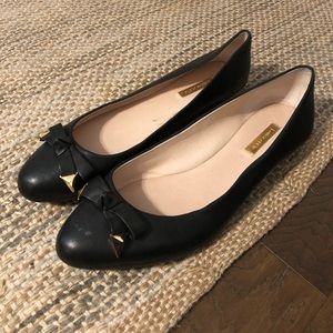 Black flats with gold detailing
